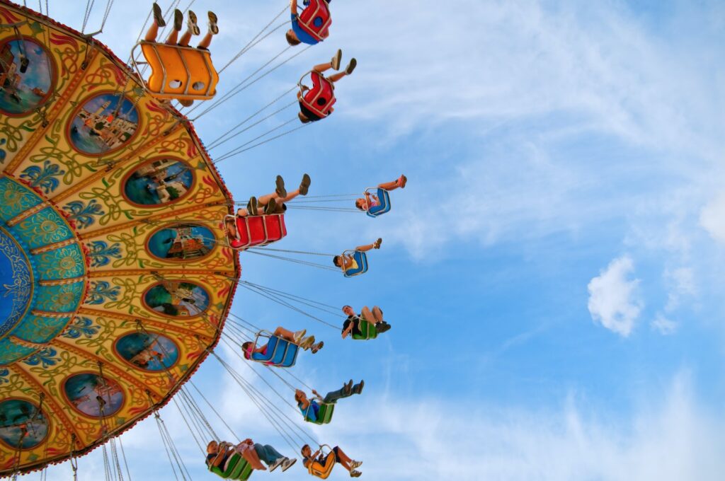 Children riding swings at a fair