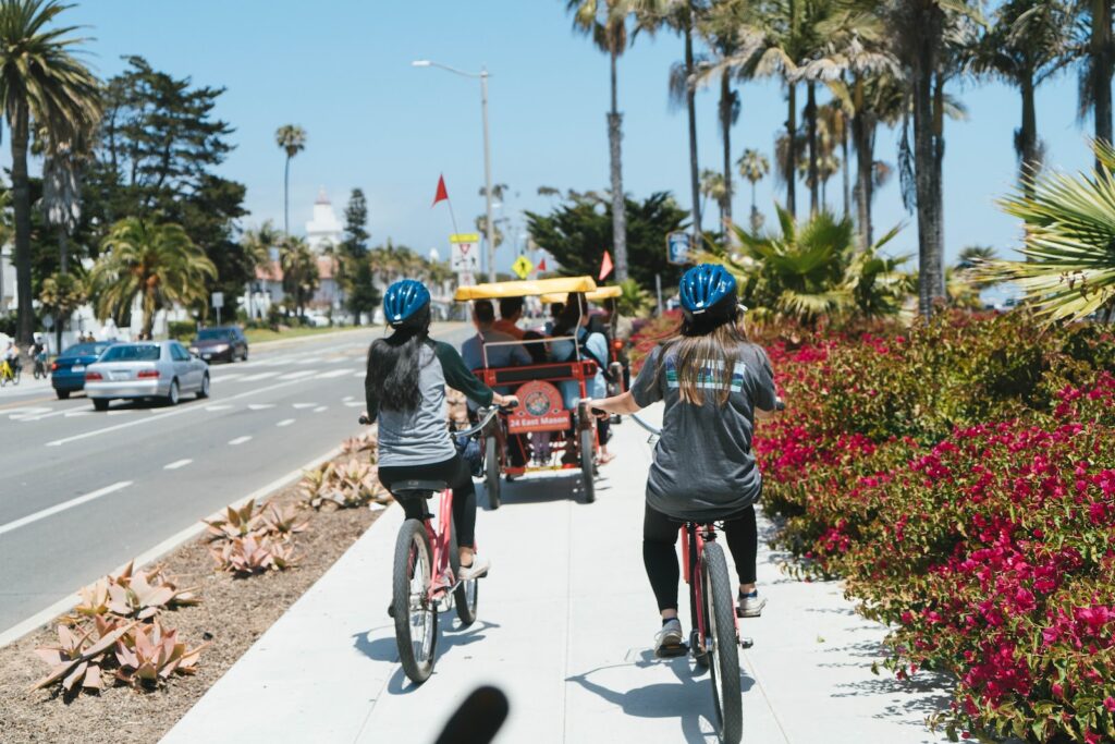 people riding bicycles on road during daytime